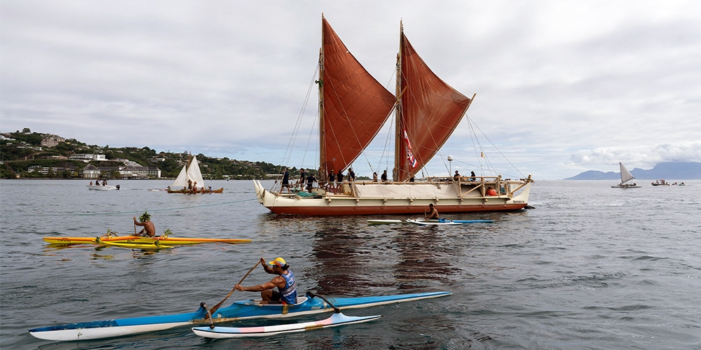 The Polynesian voyaging canoe, the Hokule'a, arrives in the port of Tahiti in 2022, after journeying from Hawaii