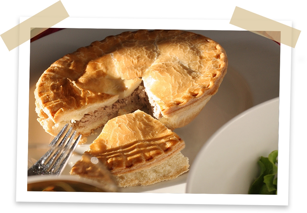 A photograph of a tortiere pie with a slice missing.