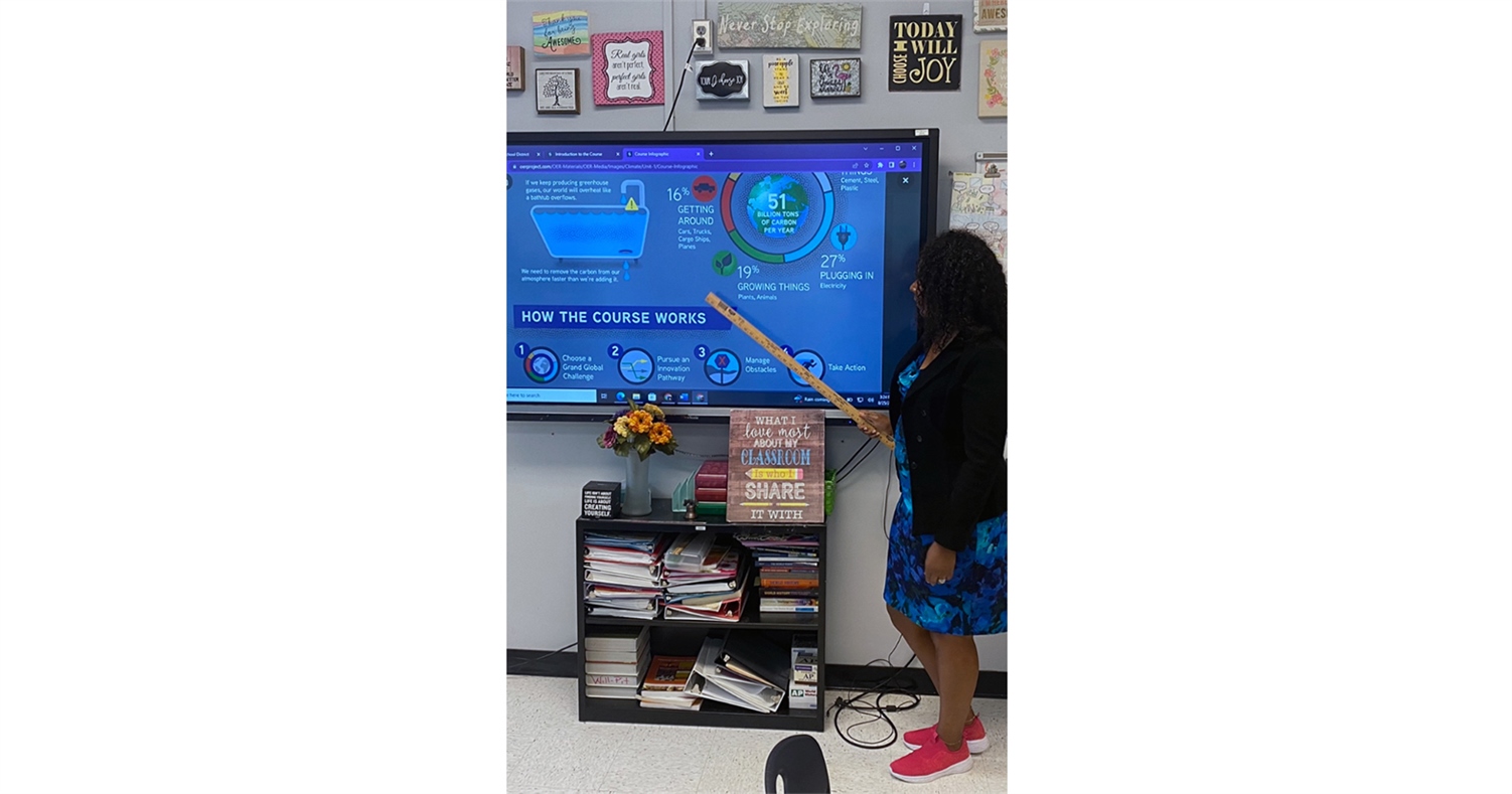 teacher standing in front of a display screen