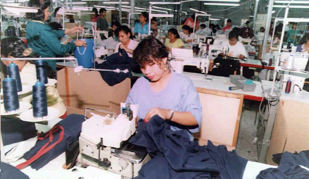 Photograph of Salvadoran workers in a crowded mid-1990s garment factory.